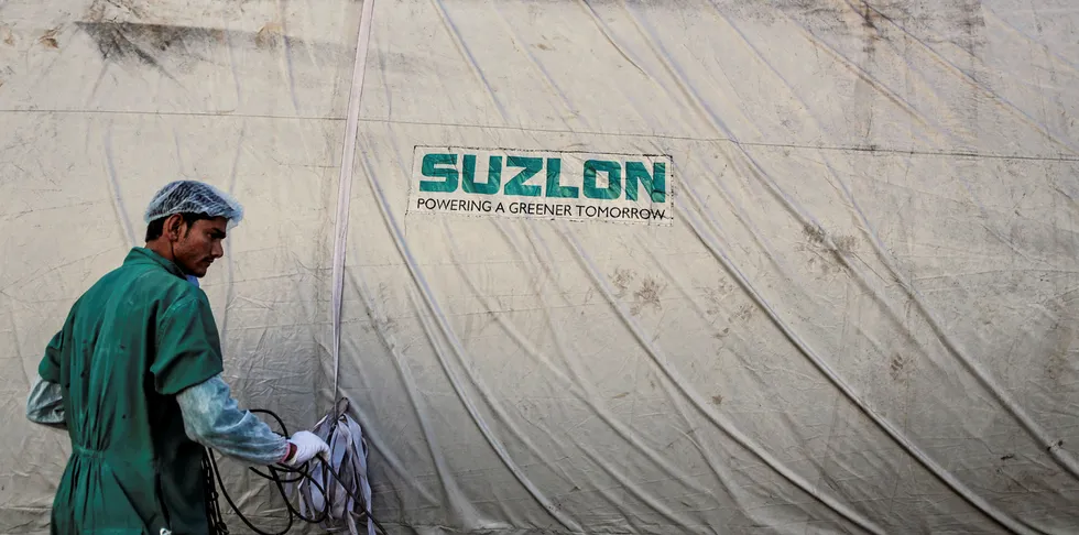 The Suzlon Energy Ltd. logo is displayed on a wind turbine blade cover at the company's rotor blade manufacturing plant in Bhuj, India.