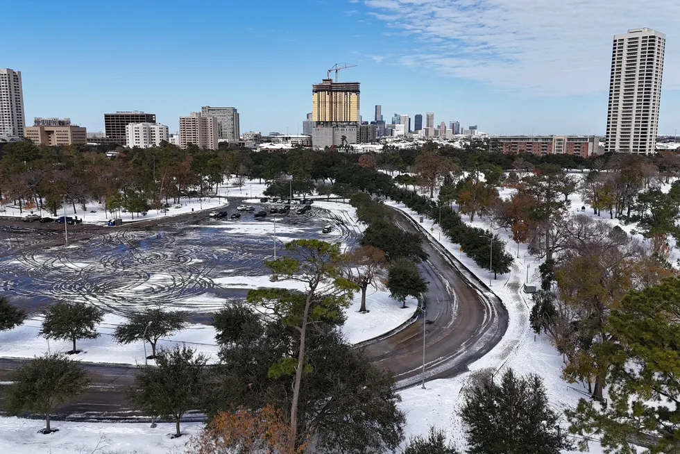 A drone picture shows snow covering Hermann Park and the downtown Houston skyline in the distance in Houston, Texas, US on 21 January 2025.