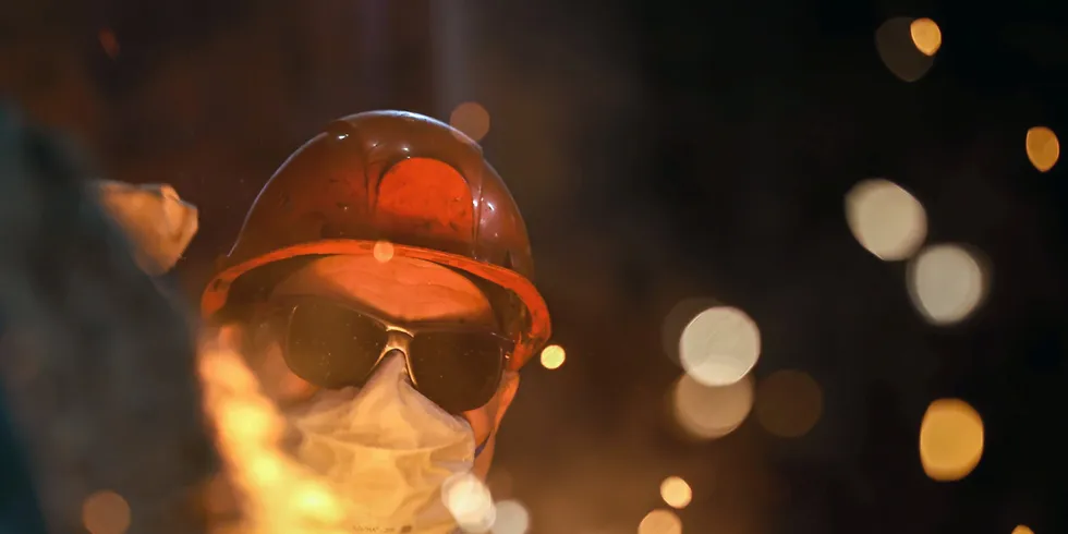 A steelmaker pours pig iron from a blast furnace