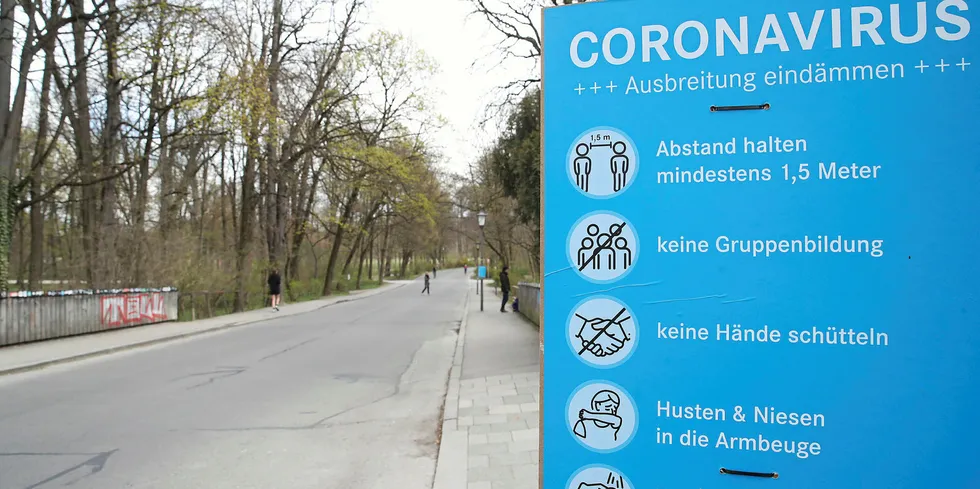 Coronavirus educational warning sing in Munich's English Garden park