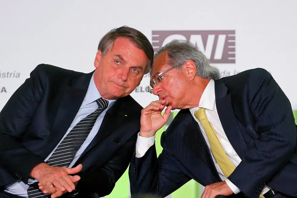 Advice: Brazil's President Jair Bolsonaro listens to his Economy Minister Paulo Guedes during a meeting with businessmen at the National Confederation of Industry (CNI) in Brasilia