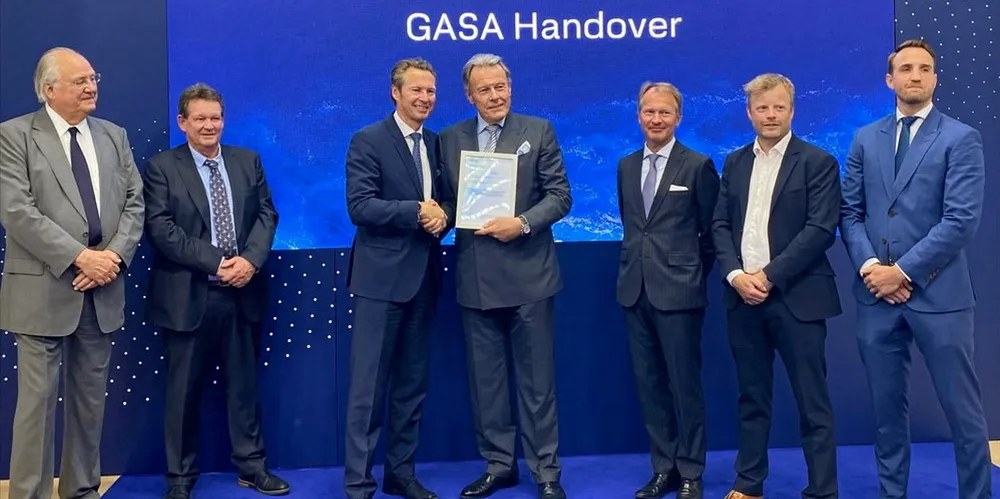 DNV Maritime chief executive Knut Orbeck-Nilssen (centre left) hands over the GASA to Knutsen NYK Carbon Carriers chair Svein Steimler today, watched by officials from KNCC and DNV.