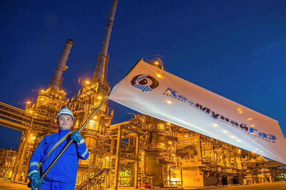 Declines across the board: a worker waiving a KazMunaigaz flag at the Atyrau oil refinery in Kazakhstan