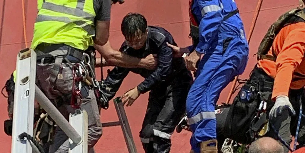 One of the four remaining seafarers aboard the 7,700-ceu Golden Ray (built 2017) is rescued from the inside of the capsized vessel
