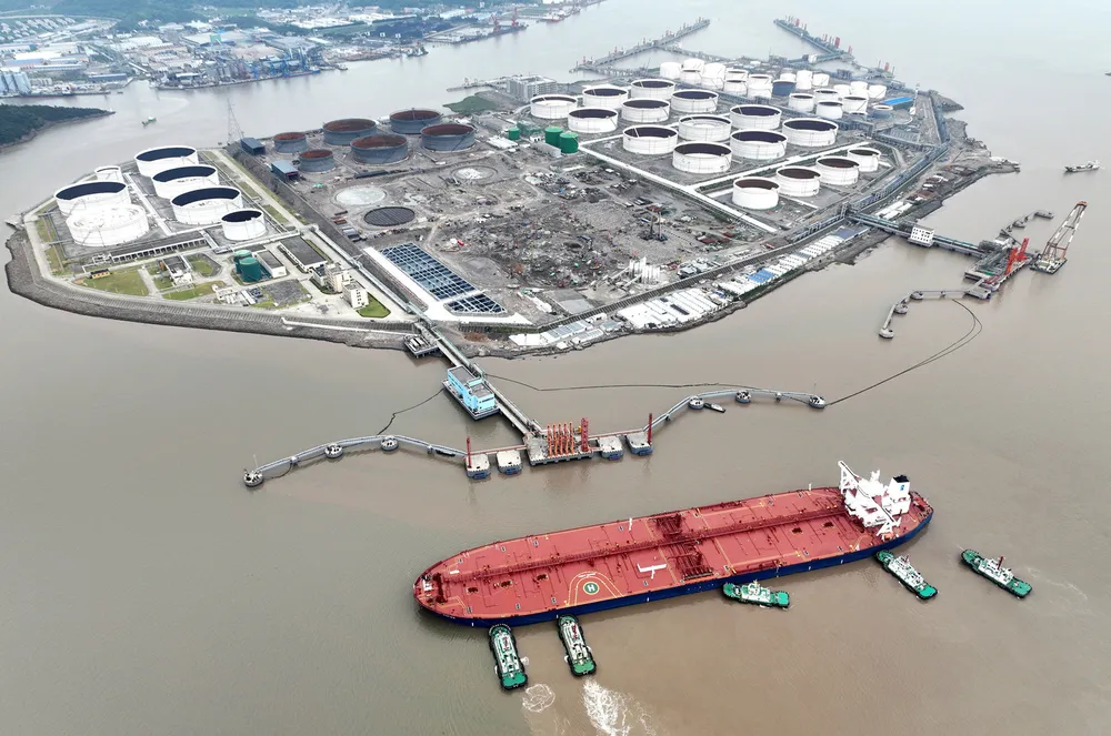Tugboats help a crude tanker berth at an oil terminal in China’s Zhejiang province, in 2022.