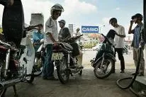 Filling up: Vietnamese motorcyclists refuel in Ho Chi Minh City