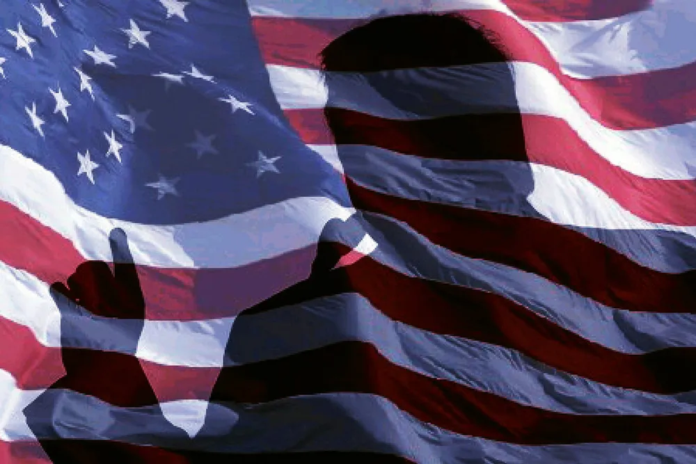 President Donald Trump's shadow across the US flag.