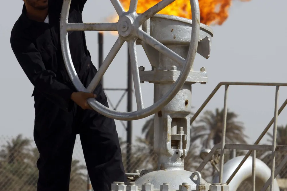 A worker operates valves at the Nahran Omar oil refinery near the city of Basra, Iraq.