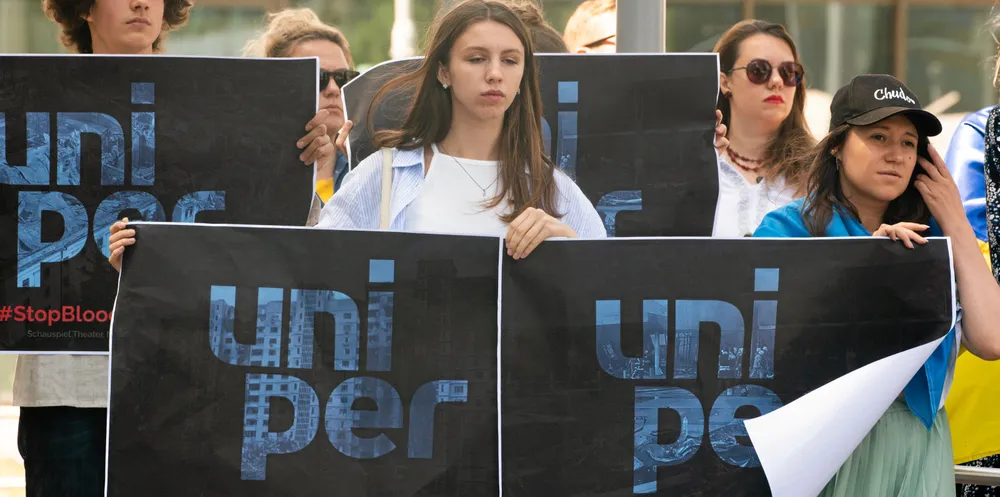 Ukrainians take part in rally against Uniper purchasing gas to financing the war in Ukraine.