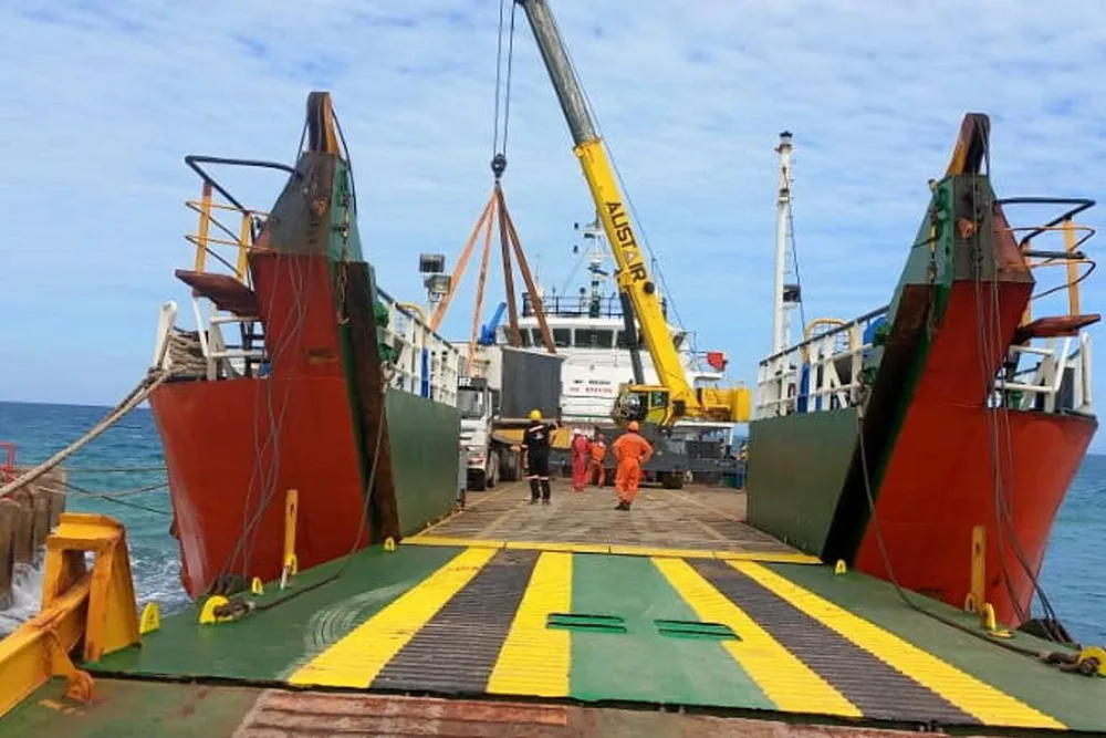 All aboard: rig equipment destined for Zimbabwe is loaded out onto a barge at Songo Songo Island in Tanzania