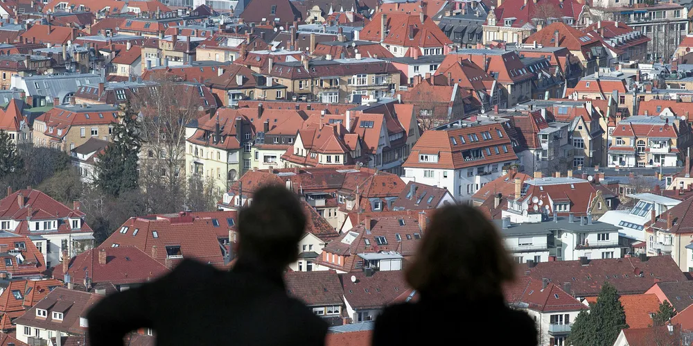 Silhouettes of a couple as they look at the southern German city of Stuttgart from a view point