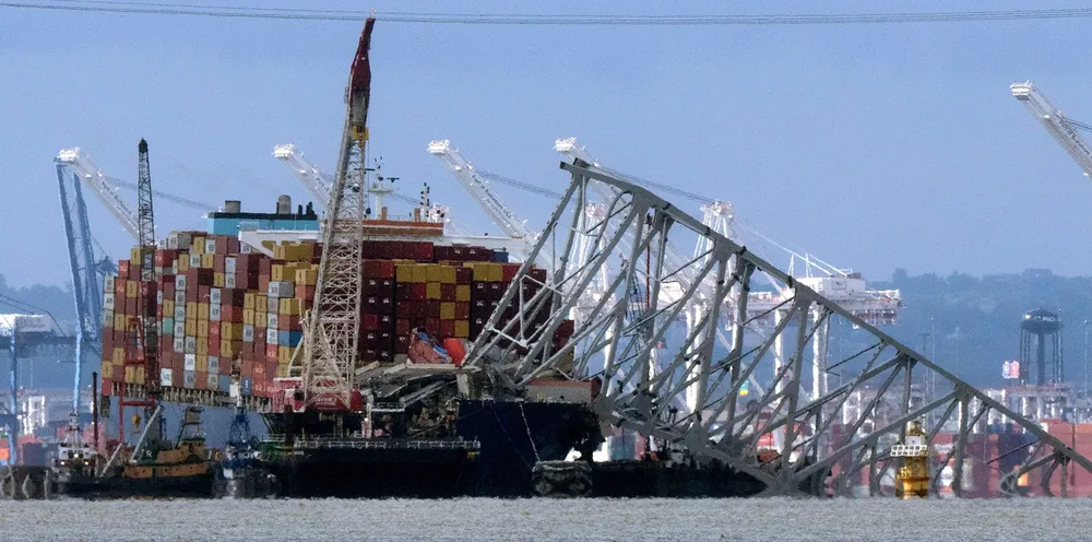 The collapsed Francis Scott Key Bridge rests on the container ship Dali on 12 May in Baltimore.