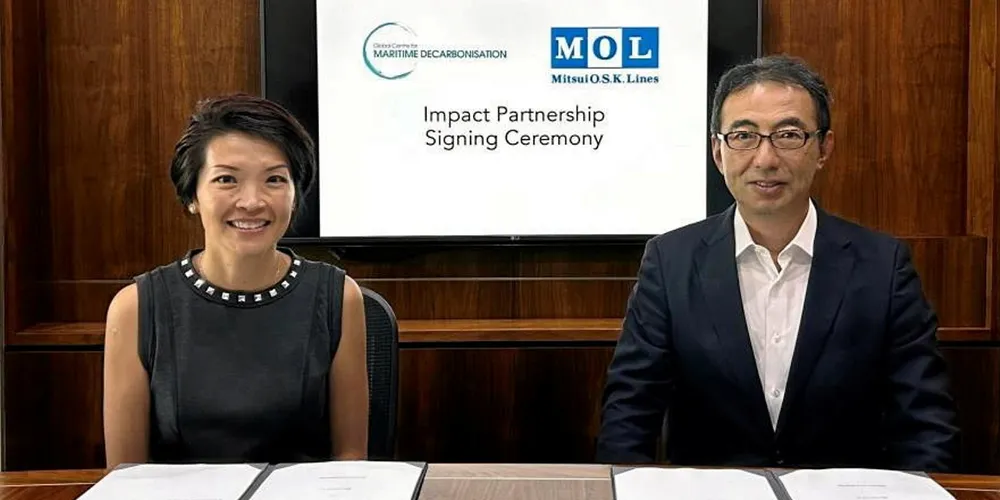 Global Centre for Maritime Decarbonisation chief executive Lynn Loo (left) signs in Mitsui OSK Lines representative director and executive vice president and chief operating officer Toshiaki Tanaka.