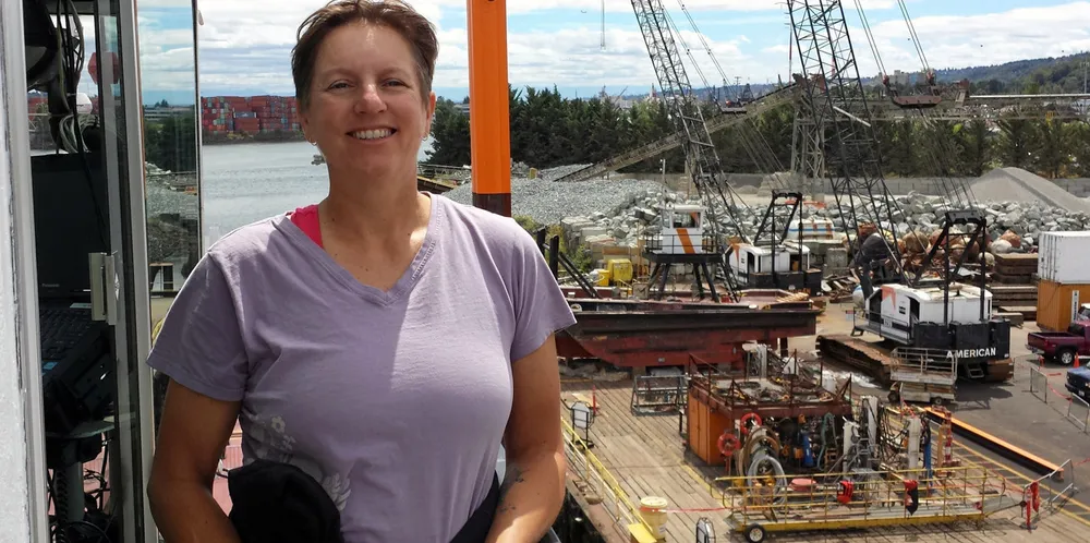 Kelli Goodwin, senior manager of marine operations at the Port of Seattle, tours a new crane barge on the Duwamish River.