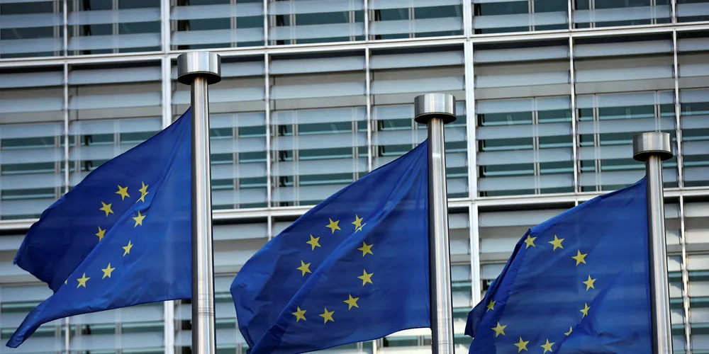EU flags fly outside the European Commission headquarters building.