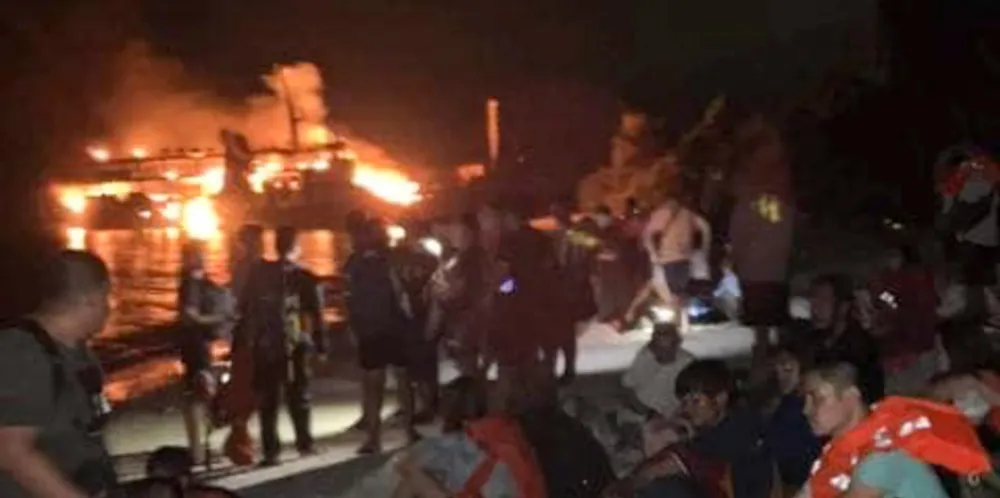 Survivors rest after being rescued from the still-burning Lady Mary Joy 3 in Basilan, southern Philippines.