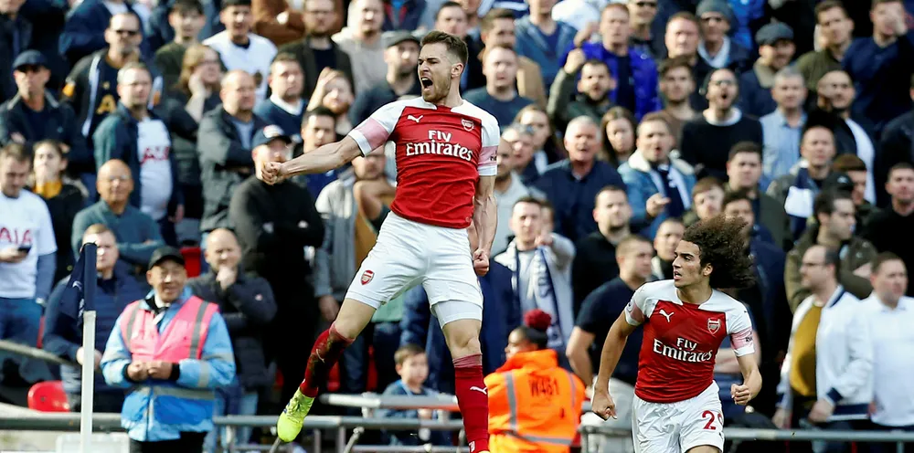 Arsenal's Welsh midfielder Aaron Ramsey (C) celebrates after scoring the opening goal of the English Premier League football match between Tottenham Hotspur and Arsenal at Wembley Stadium in London, on March 2, 2019.