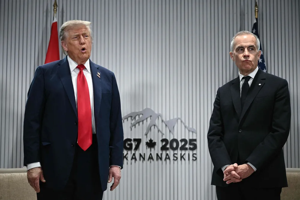 US President Donald Trump speaks to the press as Canadian Prime Minister Mark Carney looks on as they meet during the Group of Seven (G7) Summit at the Pomeroy Kananaskis Mountain Lodge in Kananaskis, Alberta, Canada on 16 June 2025.