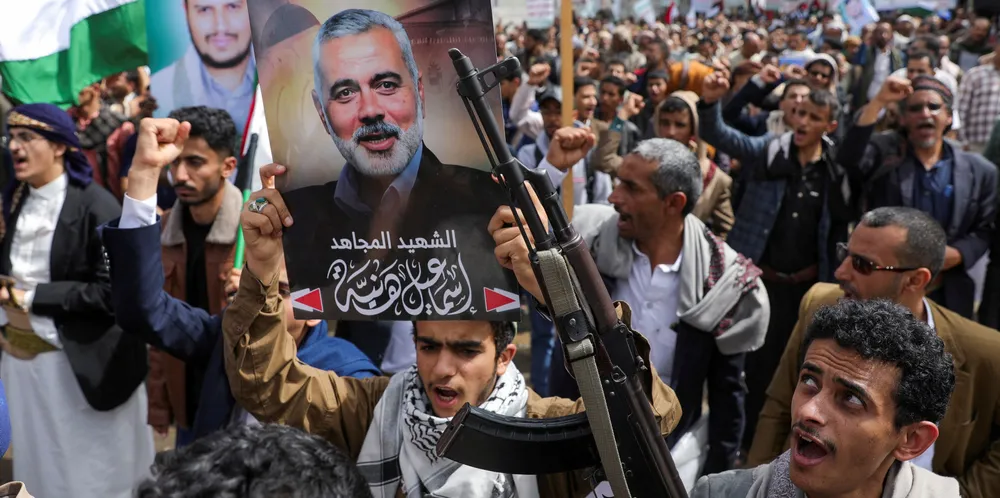 A protester holds a poster of assassinated Hamas chief Ismail Haniyeh during a protest to show solidarity with Palestinians.