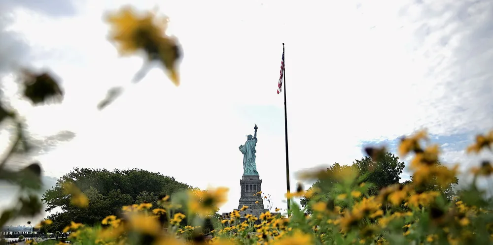 Flowers are seen on the reopened Liberty Island in front of the Statue of Liberty.