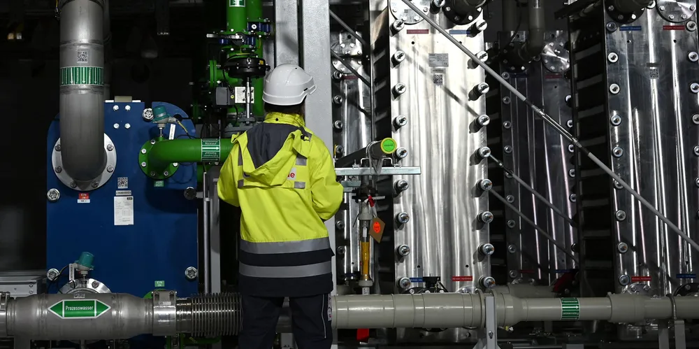 An employee of Air Liquide stands in front of an electrolyser called Trailblazer, which is expected to produce 2,900 tonnes of hydrogen each year in Oberhausen, Germany.