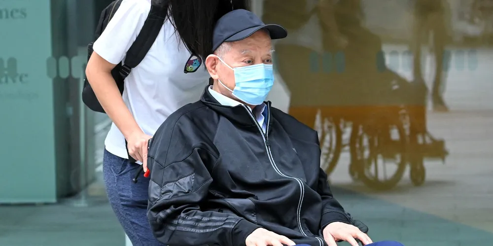 Singapore’s former oil tycoon Lim Oon Kuin arrives to be sentenced at the State Court in Singapore.