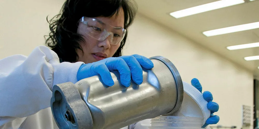 An FDA microbiologist prepares seafood samples blended with an enrichment broth to be tested for microorganisms.