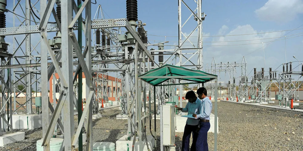 Indian technicians take a reading at a power transmission distribution facility collected from wind turbines near Jasdan town, some 200km from Ahmedabad.