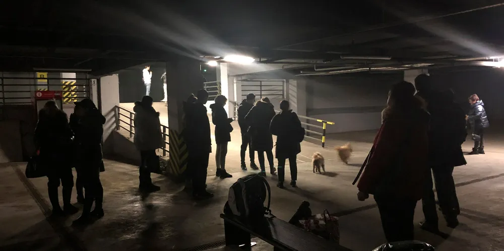 People stand in an underground car park being used as a bomb shelter in Odessa, Ukraine.