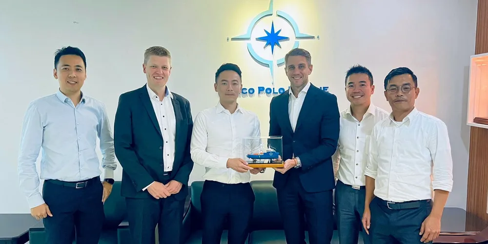 Executives from Marco Polo Marine and Vestas pose for a photograph after the contract signing.