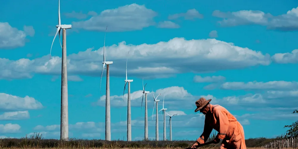 A farmer tends a field by the Vamcruz wind facility in Rio Grande do Norte, Brazil.