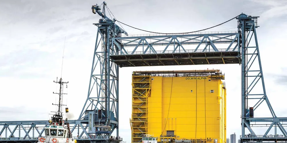 The DolWin Alpha converter platform travels under the raised Botlekbrug near Rotterdam, on its way from Zwijndrecht to Schiedam