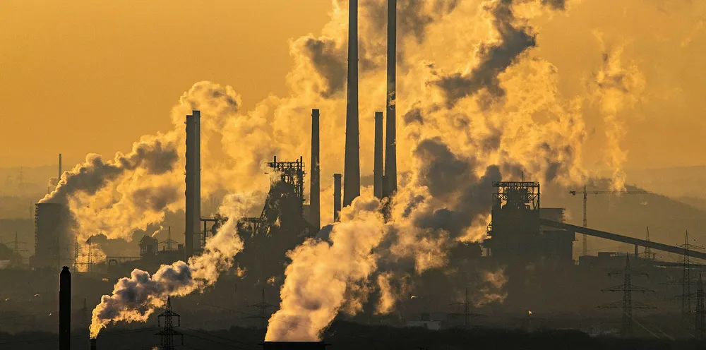 Steam and exhaust rise from the chemical company Oxea (front) and the coking plant KBS Kokereibetriebsgesellschaft Schwelgern GmbH (behind) on a cold winter day.