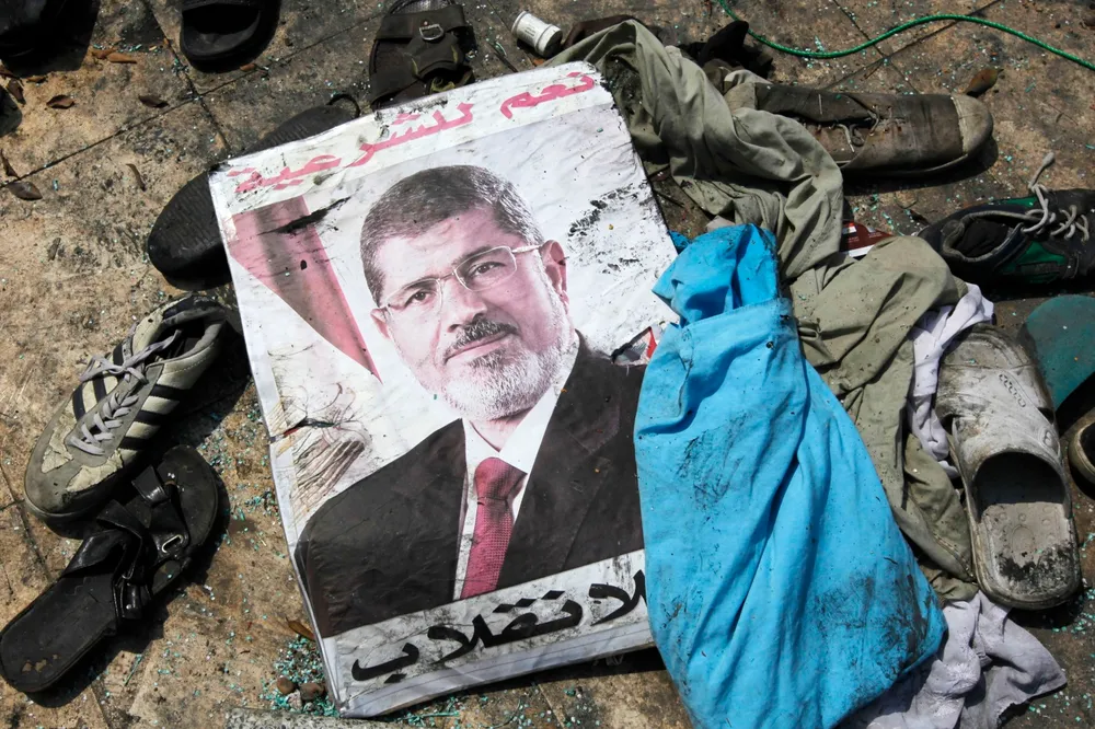Aftermath: a poster of deposed Egyptian leader Mohamed Mursi lies among the debris of a Cairo protest camp cleared by security forces