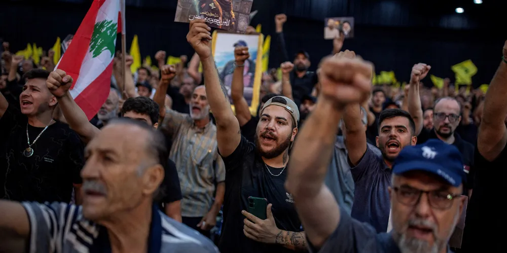 Supporters shout slogans during a ceremony marking the first week since the killing of Hezbollah commander Fuad Shukr.