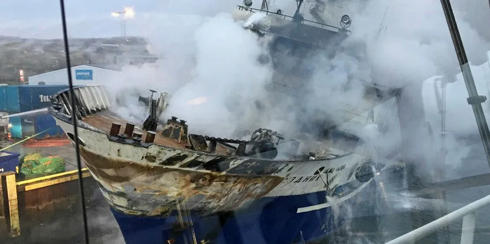 The Russian fishing trawler Bukhta Naezdnik engulfed in smoke and listing.