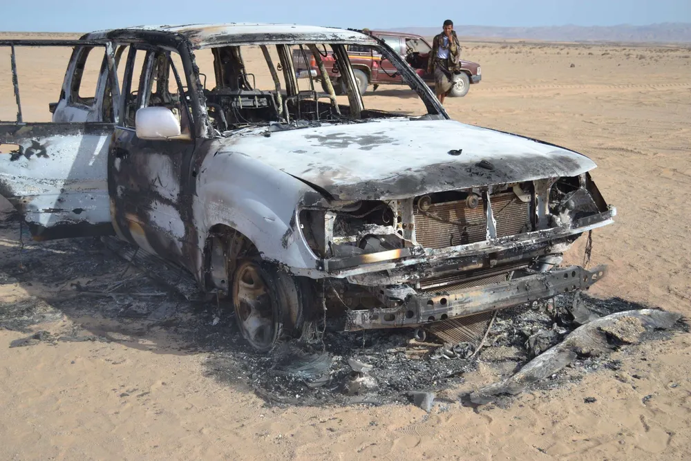 Under attack: A burnt out car seen nearby May's attack on a gas pipeline in Yemen's Shabwa region