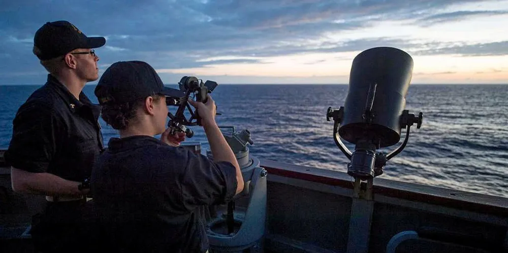 Two US Merchant Marine Academy cadets aboard a US Navy ship in 2016. Academy students spend time aboard ships to gain experience.