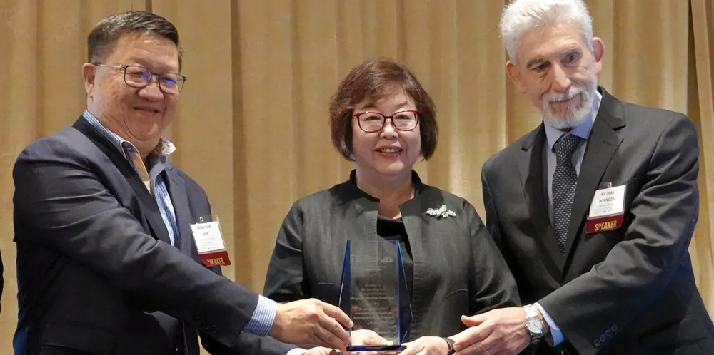 Singapore’s ‘First Lady of Shipping’ Tan Beng Tee receives the Capital Link Shipping Leadership award from Pacific Carriers CEO Hor Weng Yu (left) and Capital Link president Nicolas Bornozis.