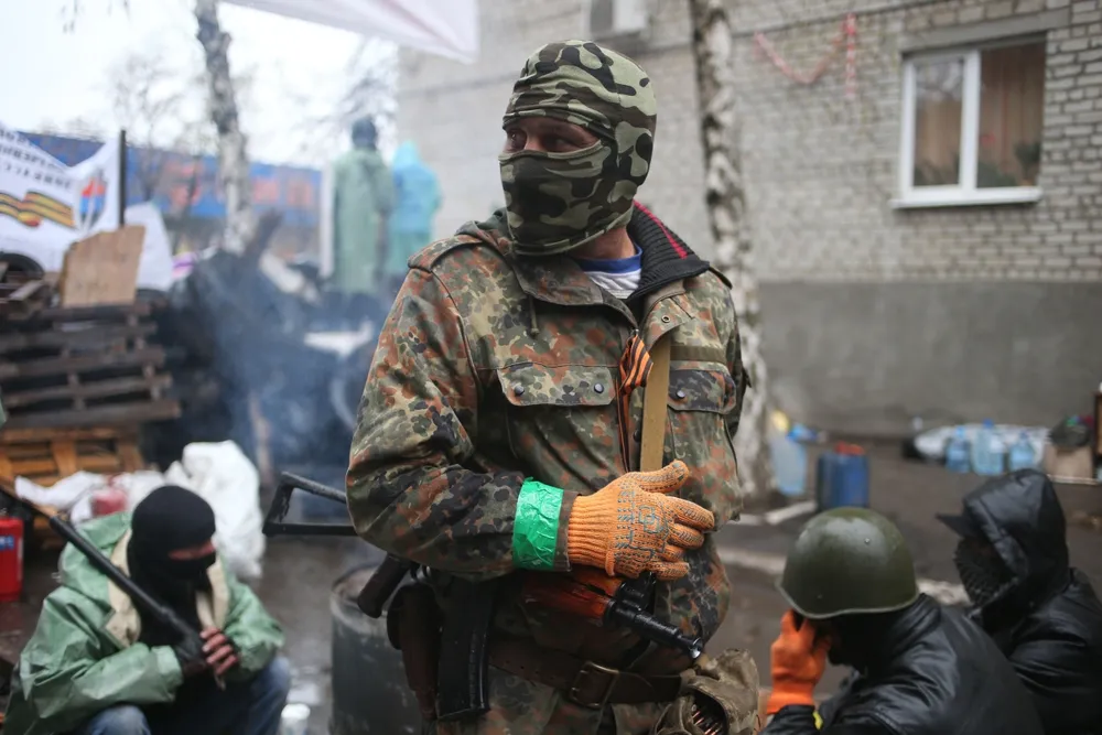 Rising tension: a pro-Russian gunman stands guard at a seized police station in the eastern Ukrainian town of Slovyansk