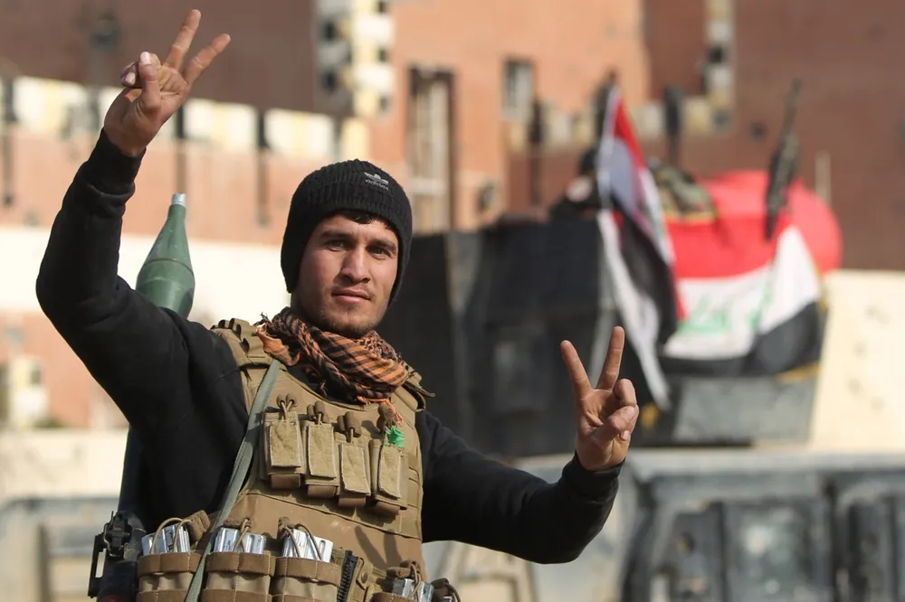 Retaken: a member of Iraq's counter-terrorism force celebrates recapture of Ramadi from IS
