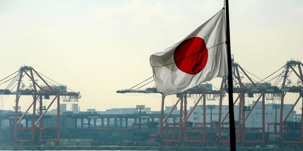 The Japanese national flag flies in front of the container pier in Tokyo port.