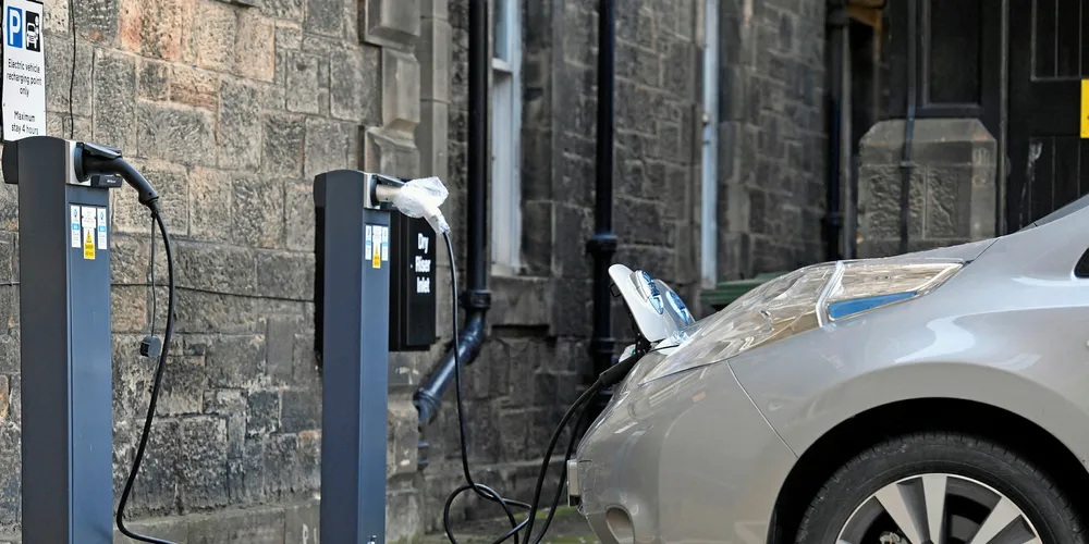 An electric vehicle recharges at a point in Edinburgh, Scotland