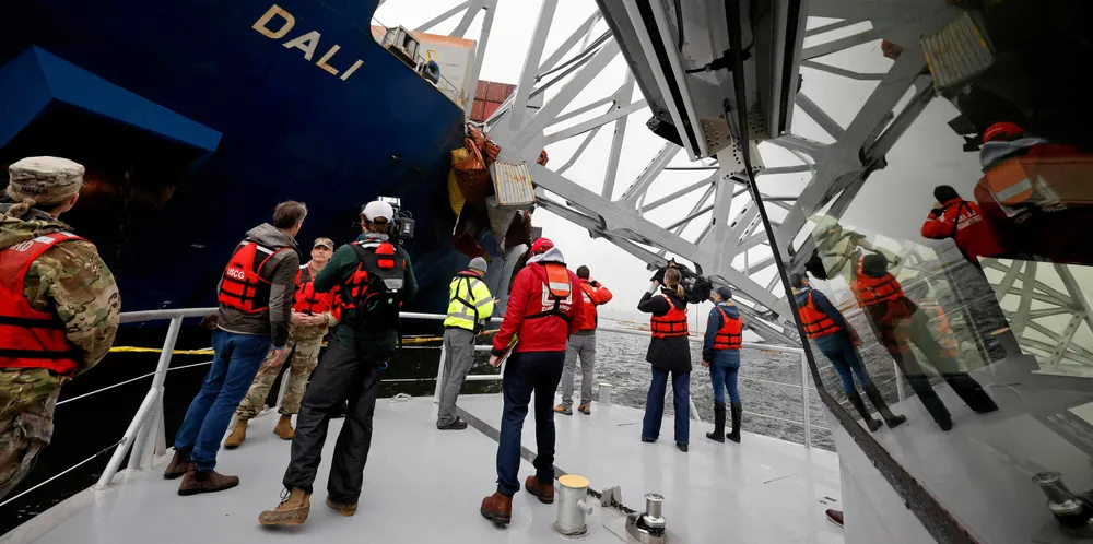 Media crews capture images of the wreckage of the container ship Dali after it crashed into the Francis Scott Key Bridge in Baltimore, Maryland.