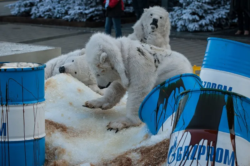 Protest: Greenpeace activists dressed as polar bears and pretended to wade through oil soaked snow in protest to Gazprom's drilling in the Arctic