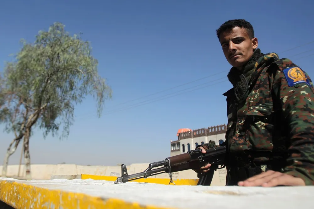 Yemen: police trooper mans a checkpoint in Sanaa