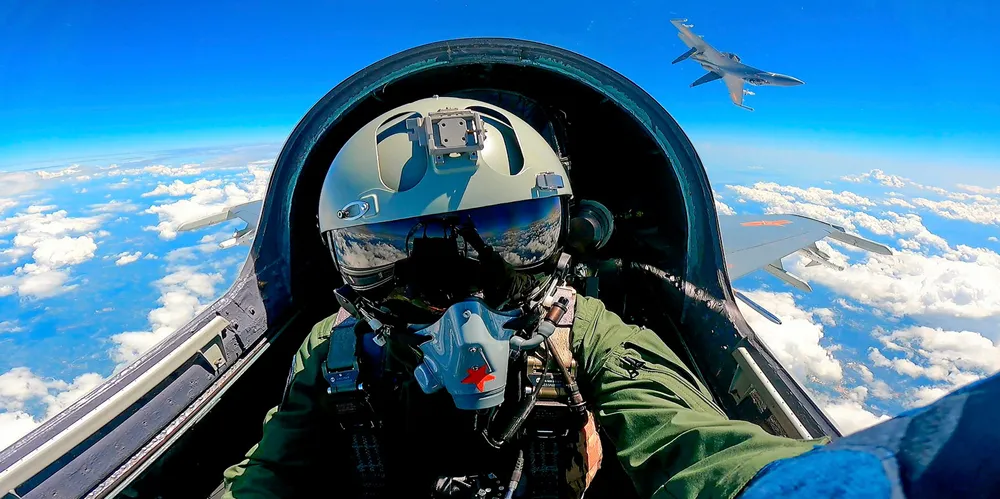 A Chinese fighter pilot takes part in three days of military exercises around Taiwan in early April, simulating sealing off the island. Any use of force against Taiwan would have devastating effects on world trade.