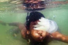 Going swimmingly: a Thai boy swims behind a jellyfish in the Songkhla province