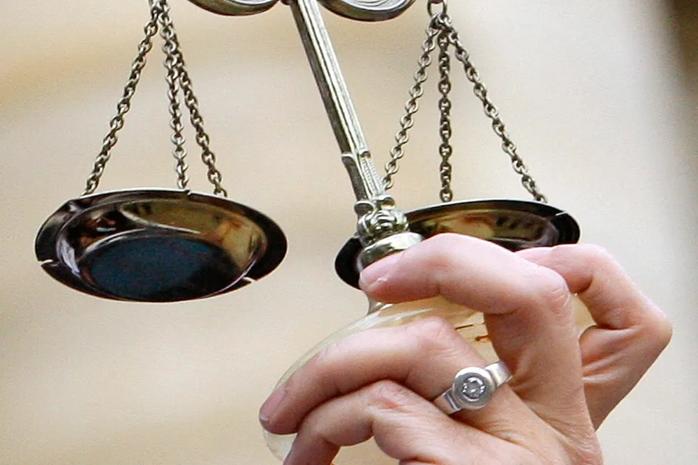 Guilty plea: a lawyer holds the scales of justice.