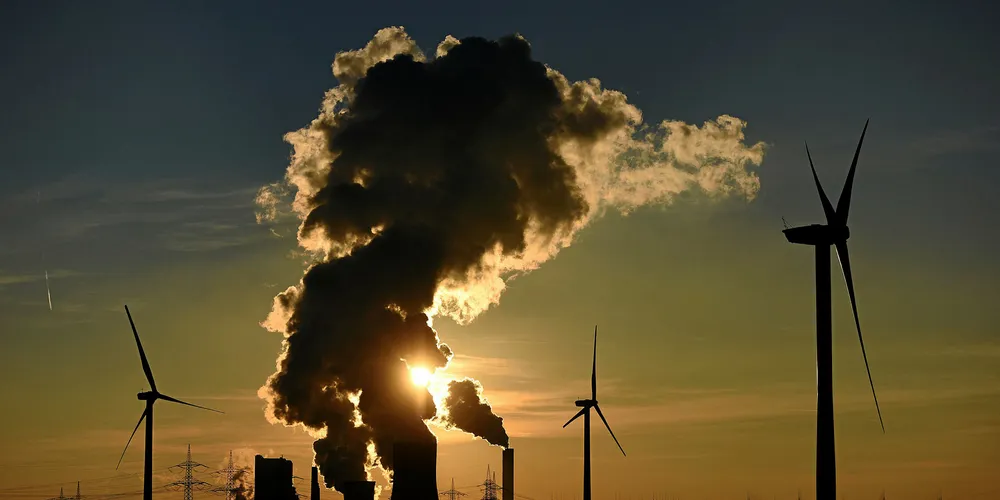 BERGHEIM, GERMANY - FEBRUARY 16: Electricity pylons and wind turbines stand beside the RWE Niederaussem coal-fired power plant while Steam rises from cooling towers on February 16, 2016 near Bergheim, Germany. Germany is maintaining ambitious goals for transitioning itself away from its traditional power sources such as coal and nuclear towards renewables, such as wind and solar. In 2015 Germany produced approximately 30% of its electricity from renewables, by 2025 it hopes to attain 40-45% and by 2035 55-60%. (Photo by Volker Hartmann/Getty Images) . Electricity pylons and wind turbines stand beside the RWE Niederaussem coal-fired power plant while Steam rises from cooling towers on February 16, 2016 near Bergheim, Germany.